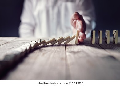 Stopping the domino effect concept for business solution, strategy and successful intervention - Shutterstock ID 674161207