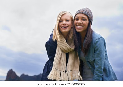 Stopping To Enjoy The View. Two Young Women Laughing Outside.