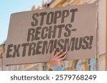 "Stoppt Rechtsextremismus!" on a cardboard banner. protest. democracy. unity. resistance. activism. solidarity. vigilance