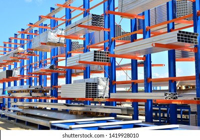 Storage of the Aluminium Profiles for Industry assembly production Line on the multi-tier aluminum rack shelf in warehouse. Steel profiles, sheet metal build-profile,  background, texture - Image