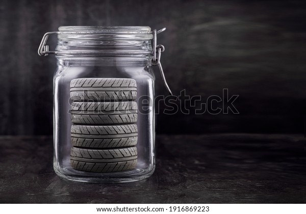 storage of car tires. The wheels are stored in a\
glass jar, concept. copy\
space