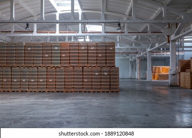 The Storage And Carriage At Industrial Food Industry Facility. A Glass Clear Bottles For Alcoholic Or Soft Drinks Beverages And Canning Jars Stacked On Pallets For Forklift.