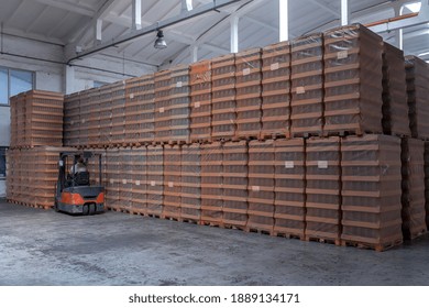 The Storage And Carriage At Industrial Food Industry Facility. A Glass Clear Bottles For Alcoholic Or Soft Drinks Beverages And Canning Jars Stacked On Pallets For Forklift.