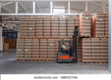 The Storage And Carriage At Industrial Food Industry Facility. A Glass Clear Bottles For Alcoholic Or Soft Drinks Beverages And Canning Jars Stacked On Pallets For Forklift.