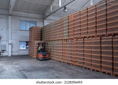 The Storage And Carriage At Industrial Food Industry Facility. A Glass Clear Bottles For Alcoholic Or Soft Drinks Beverages And Canning Jars Stacked On Pallets For Forklift.