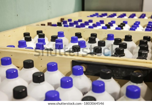 Storage and
storage of chemical liquids. Smooth rows of liquid containers in
wooden boxes. Background of bottles stored in the warehouse. The
concept of warehousing and storage of
goods