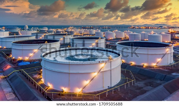Storage of chemical products like oil, petrol,\
gas, Aerial view oil storage tank terminal and tanker, petrol\
industrial zone, Business commercial trade fuel and energy\
transport by tanker\
vessel.