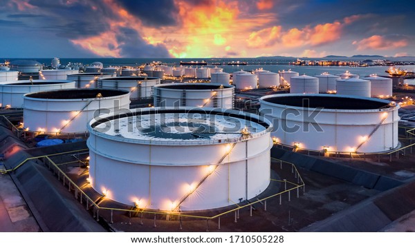 Storage of chemical products like oil, petrol,\
gas, Aerial view oil storage tank terminal and tanker, petrol\
industrial zone, Business commercial trade fuel and energy\
transport by tanker\
vessel.