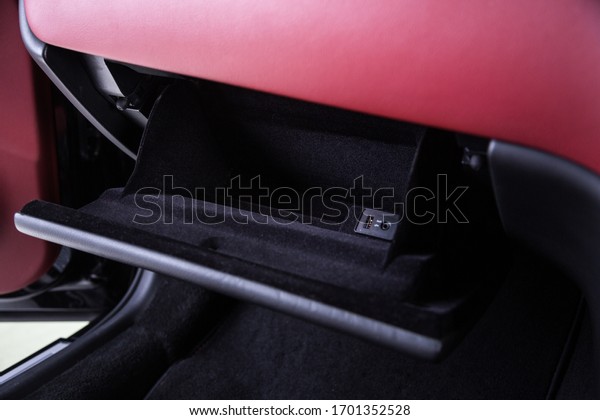 Storage\
compartment in red leather car\
interior	\

