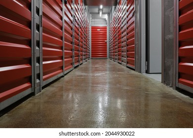 Storage Corridor Warehouse. Self Storage Facility, Red And Gray Metal Doors With Locks. Moving, Organizing, Storage Concept.