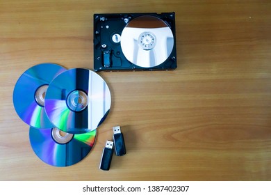 Storage device, hard disk, DVD, flash drive, placed on a wooden table