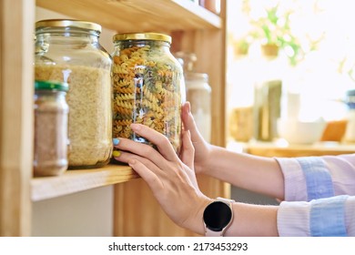 Storage of food in the kitchen in pantry, woman's hands with jar of colored paste - Powered by Shutterstock