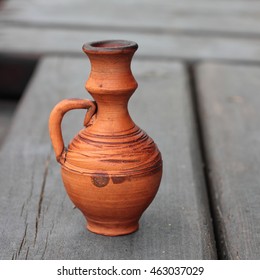 Storage for liquids - Old Vintage jug ewer on darkly brown wooden background. - Shutterstock ID 463037029