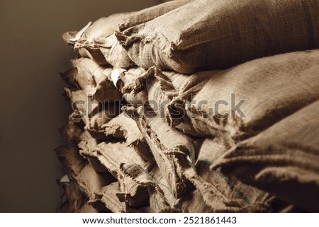 Storage of Raw Coffee Beans in Warehouse with Stacked Burlap Sacks 