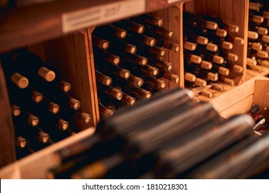 Storage Room With Bottles Of Alcoholic Drink In Wooden Racks