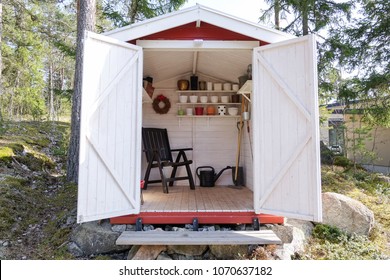 Storage Shed Filled With Garden Tools. Shovels, Rake, Pots, Water Pitcher And All You Need For Gardening.