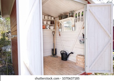 Storage Shed Filled With Garden Tools. Shovels, Rake, Pots, Water Pitcher And All You Need For Gardening.