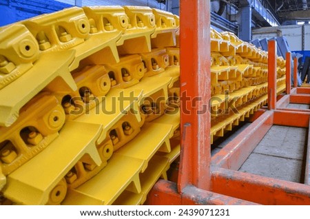 A storage station for crawler chains on the assembly line of crawler bulldozers. Crawler bulldozer assembly line. Heavy industry. Construction equipment.