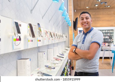 Store Assistant Standing Arms Crossed In A Phone Store