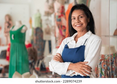 Store attendant looks at the camera and smiles in a neighborhood trade - Shutterstock ID 2289074239