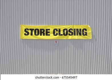 Store Closing Sign Hanging On The Concrete Wall