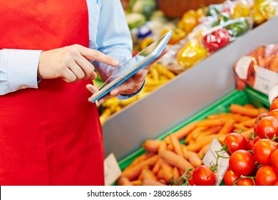 Store Manager Doing Warehouse Management With Tablet Computer In A Supermarket