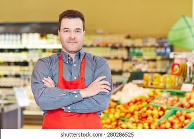 Store Manager Standing With His Arms Crossed In A Supermarket