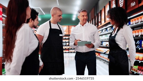 Store Manager In Supermarket Meeting With Team. Management Planning - Powered by Shutterstock