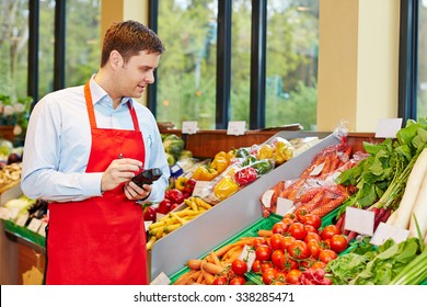 Store Manager In Supermarket Ordering Fresh Vegetables With Mobile Data Registration Terminal