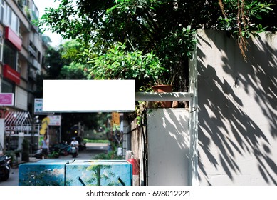 Store sign with tree shadow
