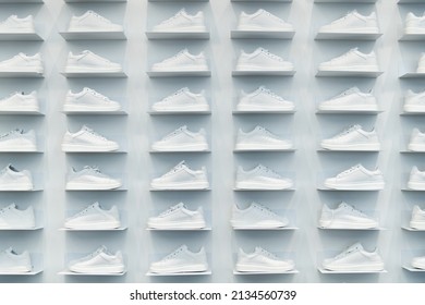 Store wall with white sneakers.