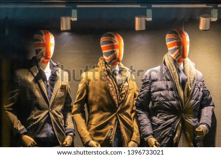 storefront with three male mannequins with British flag face