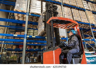 Storehouse Employee During Driving On Forklift In Warehouse