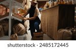 Storekeeper arriving in eco friendly supermarket with freshly harvested organic food stock. Trader restocking local neighborhood grocery shop with chemicals free vegetables while chatting with client