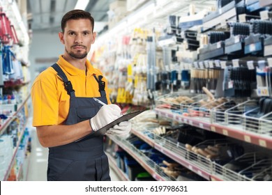 Storekeeper counting stock in hardware shop - Shutterstock ID 619798631