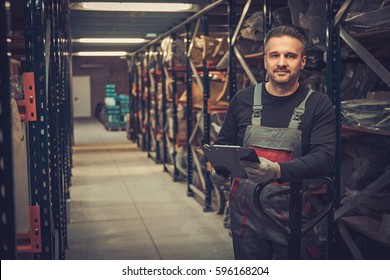 Storekeeper with manual pick list on a warehouse - Shutterstock ID 596168204