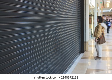 Stores show case in shopping mall closed due to sanctions, boycott and embargo, mass market cloth shops work stoppage with closed storefronts, retail business suspension and brands leaving market - Shutterstock ID 2140892111