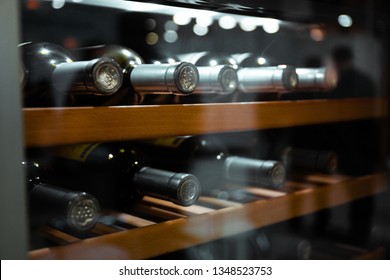 Storing bottles of wine in fridge. Alcoholic card in restaurant. Cooling and preserving wine.