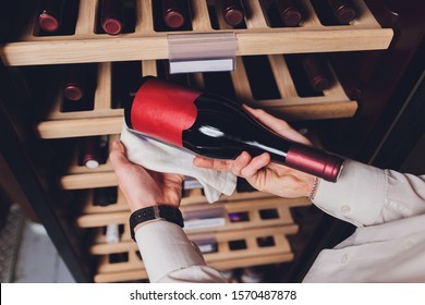Storing bottles of wine in fridge. Alcoholic card in restaurant. Cooling and preserving wine.
