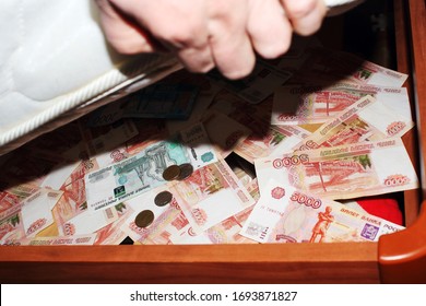 Storing Money Under The Bed. Russian Rubles Are Hidden In Banknotes And Coins.