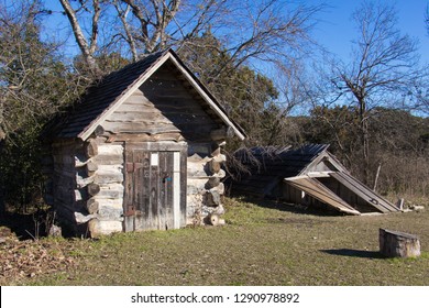 A Storm Cellar And A Log Building In A Pioneer Farm