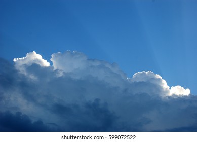 Storm Cloud, Illuminated By The Sun, You See The Sun Rays Behind The Clouds, Day Image. 