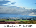 Storm Cloud over Cheviot Hills from Simonside Hills, covered with heather in late summer, they are part of Northumberland National Park near Rothbury, overlooking Coquetdale and the Cheviot Hills