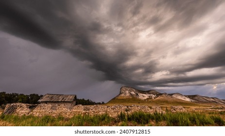 Storm cloud sky dramatic weather landscape nature thunderstorm dark ominous cloudy overcast atmosphere severe rain thunder lightning outdoor countryside rural. Field mesa butte rock formation geology scenic southwest desert