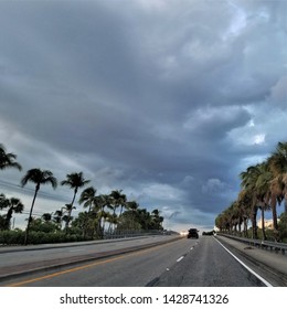 Storm Clouds Above A Palm Tree Lined Street