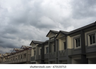Storm clouds background with home