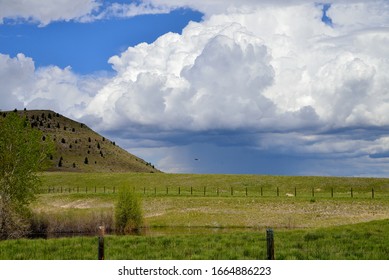 Storm clouds form behind the Scratch Gavel Hills near Helena, Montana, with and eagle riding the currents.