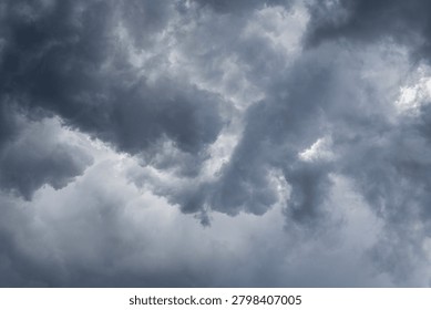 Storm clouds form in the sky with the sun shining behind them, creating good rim lighting and a good background with room for copy. 