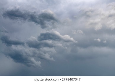 Storm clouds form in the sky with the sun shining behind them, creating good rim lighting and a good background with room for copy. 