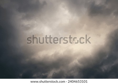 Storm clouds gather, creating a dramatic and moody overcast sky                               